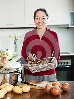 Mature woman with dried mushrooms