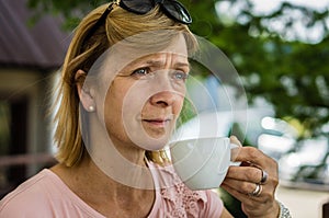 Mature woman drinking a drink in nature