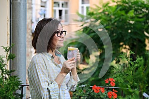 Mature woman drinking water with lemon. Natural antioxidant, diet drink