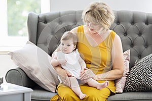 Mature woman embrace with baby girl