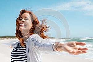 Mature woman enjoy breeze at beach