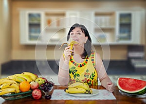 A mature woman enjoys life while eating bananas