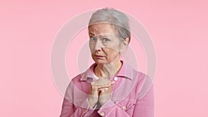 Mature Woman Exhibiting Discomfort and Guilt in Pink Outfit