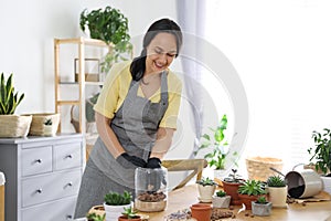 Mature woman with expanded clay and succulent plants. Engaging hobby