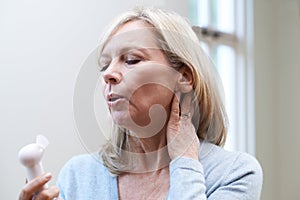 Mature Woman Experiencing Hot Flush From Menopause