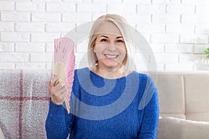 Mature woman experiencing hot flush from menopause