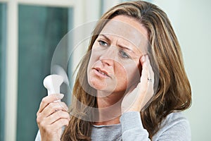 Mature Woman Experiencing Hot Flush From Menopause