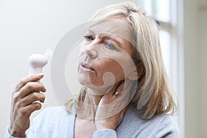 Mature Woman Experiencing Hot Flush From Menopause photo