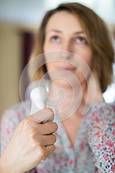 Mature Woman Experiencing Hot Flush From Menopause Using Electric Fan photo