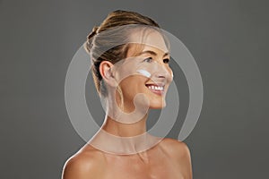 Mature woman, face cream or sunscreen in skincare routine for healthy glow, sun damage protection or healthcare wellness
