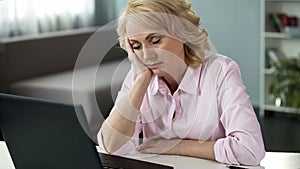 Mature woman falling asleep at workplace, lack of vitamins and energy, tired