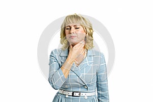 Mature woman feeling pain in throat.