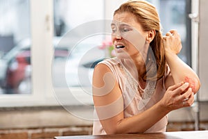 Mature woman feeling sick having rash and scratches on body