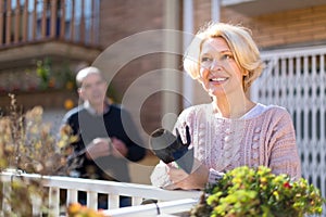 Mature woman gardening in patio