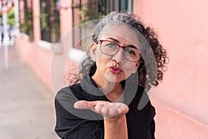 Mature woman in glasses posing in the city