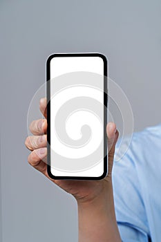 Mature woman hand holding smartphone with white screen  on white background. Modern phone with touch screen in