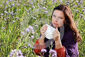 Mature woman with handkerchief in a flower field