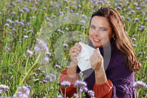Mature woman with handkerchief in a flower field