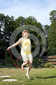 Mature woman has fun jumping rope