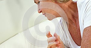 Mature woman having a headache and lying