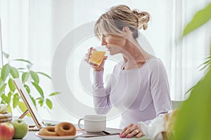 Mature woman having a relaxing breakfast at home