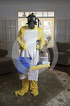 Mature woman in Haz Mat suit with blue bucket and mop photo