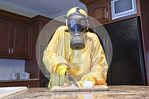 Mature woman in Haz Mat suit chopping onions photo