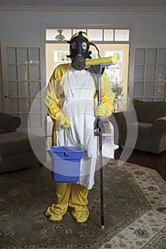 Mature woman in Haz Mat suit with mop and bucket photo