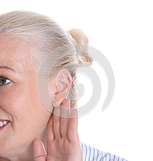 Mature woman with hearing problem on white background,