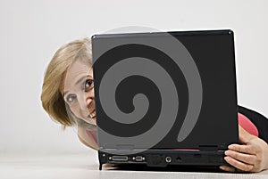 Mature woman hide behind laptop