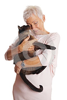 Mature woman holding cat in her arms