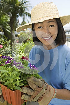Mature Woman Holding Flower Pot