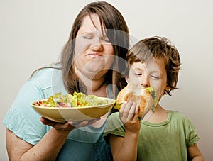 Mature woman holding salad and little cute boy