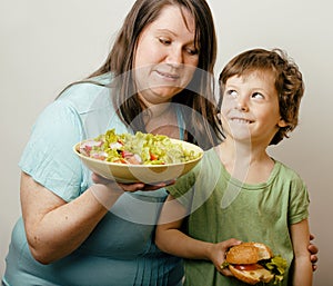 Mature woman holding salad and little cute boy