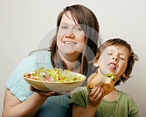 Mature woman holding salad and little cute boy