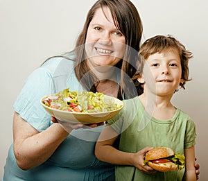 Mature woman holding salad and little cute boy