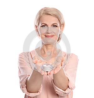 Mature woman with jar of anti-aging face cream on white