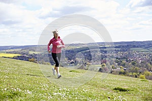 Mature Woman Jogging In Countryside