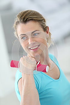 Mature woman lifting dumbbells