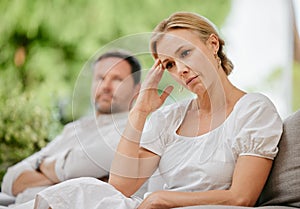 Mature woman looking upset and annoyed after arguing with her husband about marriage problems. Feeling negative. This