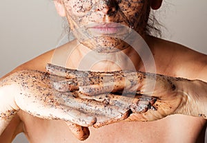 Mature woman making cosmetic mask