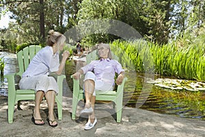 Mature woman and mother relaxing with man and child fishing in the background