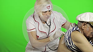 Mature woman nurse doctor examines senior patient sailor man with problems