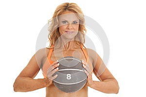 Mature woman orange bra medicine ball in front