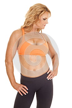 Mature woman orange bra stand look side