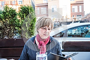 Mature Woman at Outdoor Cafe