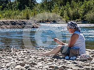 Mature Woman outdoors on river bank
