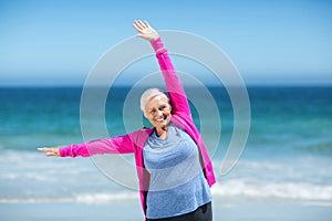Mature woman outstretching her arms