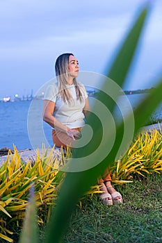 Mature woman pensive sitting in park