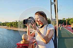 Mature woman photographer with camera taking photo picture